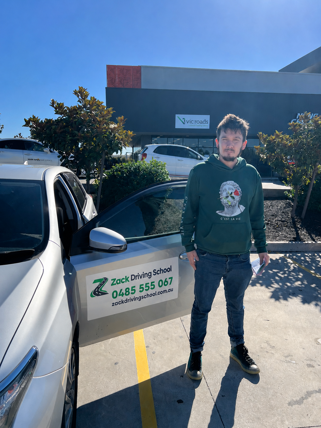 Zack Driving School learner with the automatic lesson car at a VicRoads testing centre